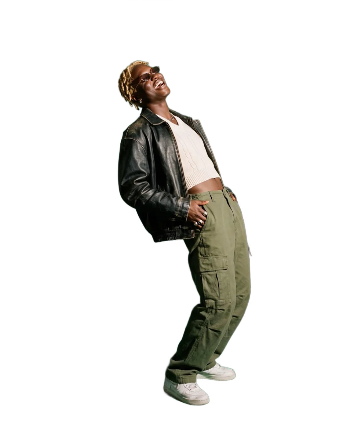A model in a vintage leather jacket, cropped knit, cargo trousers and tinted shades